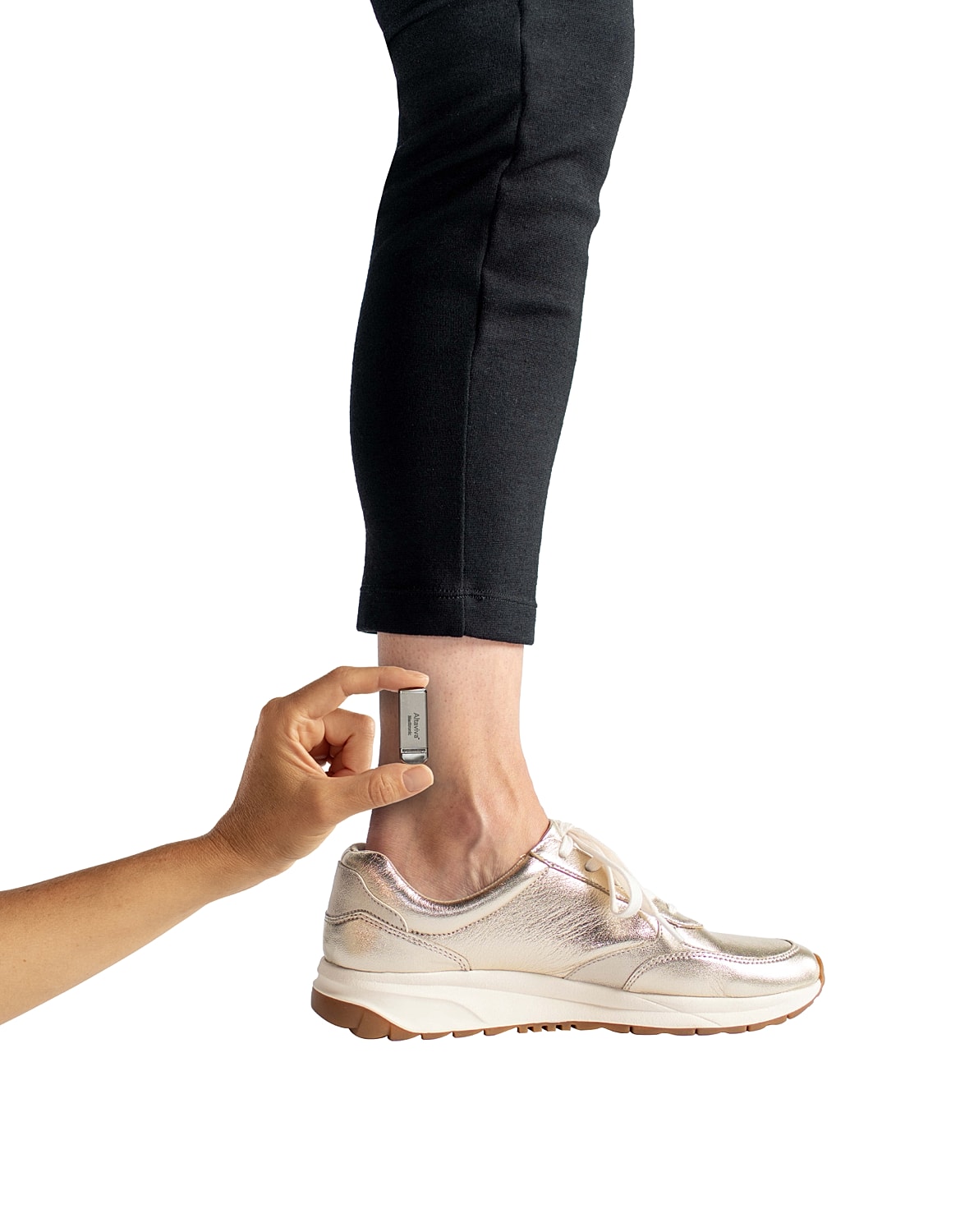 Hand measuring ankle with a Columbia Altiviva device near sneaker.