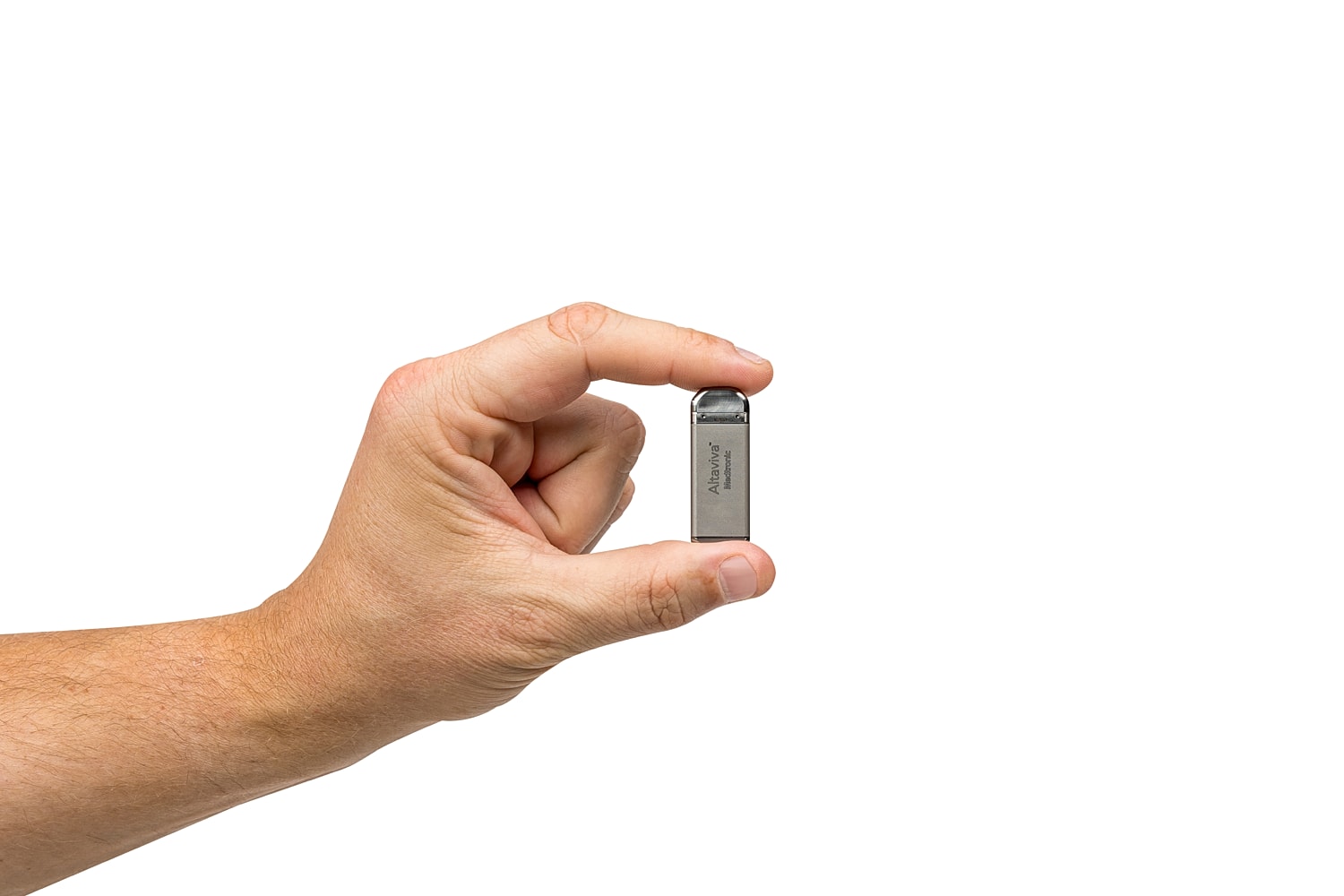 Hand holding a small USB drive.