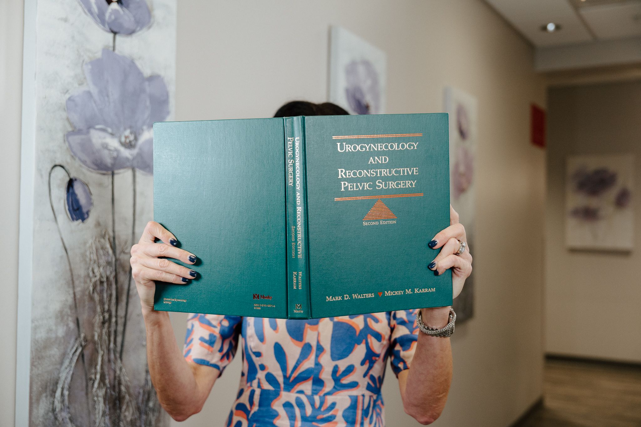 person holding book about urogynecology