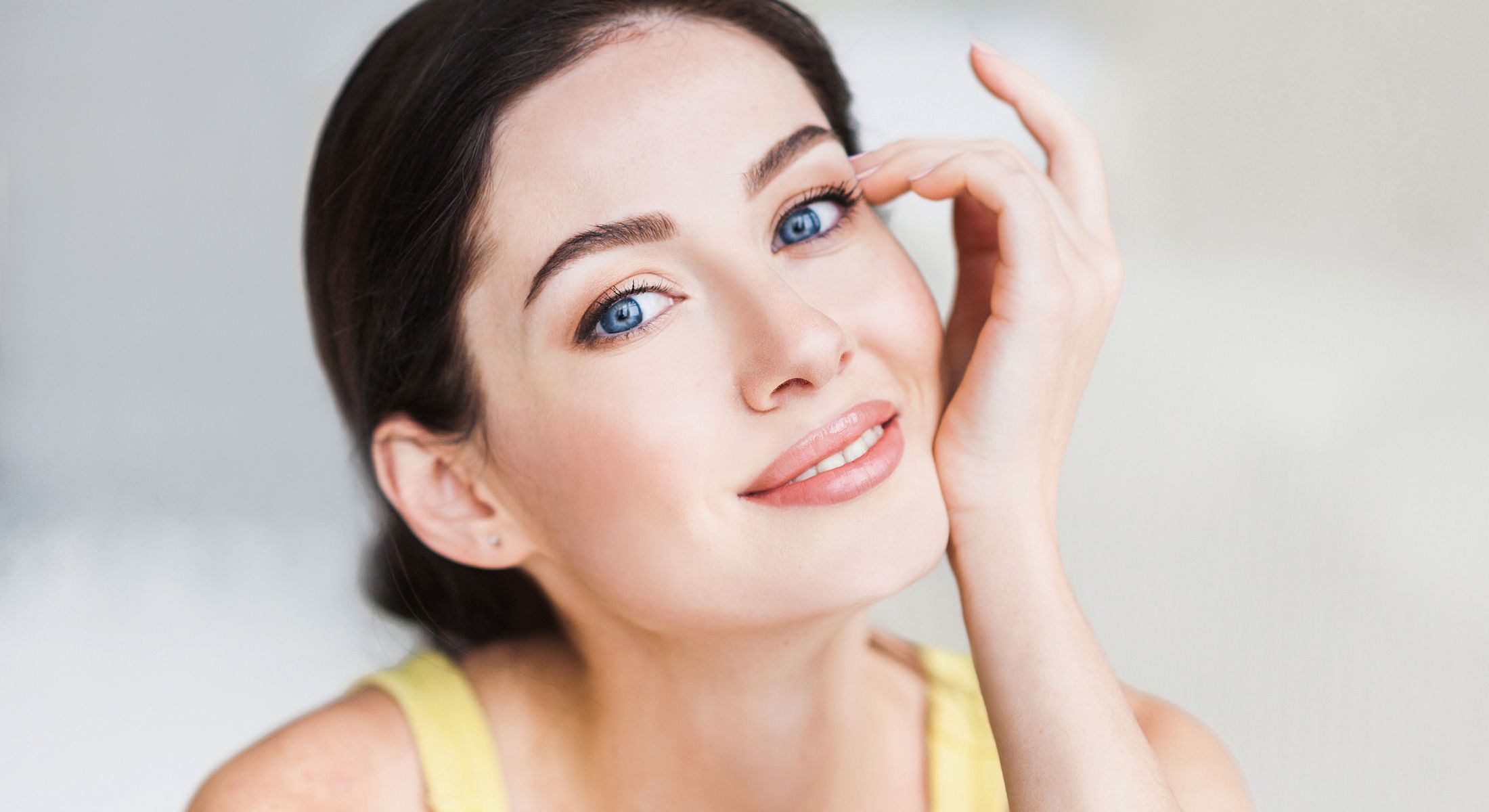 Smiling West Columbia laser hair removal woman with blue eyes and natural makeup.